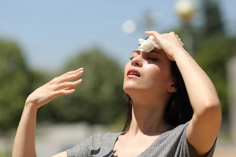 Woman wiping forehead on a hot day